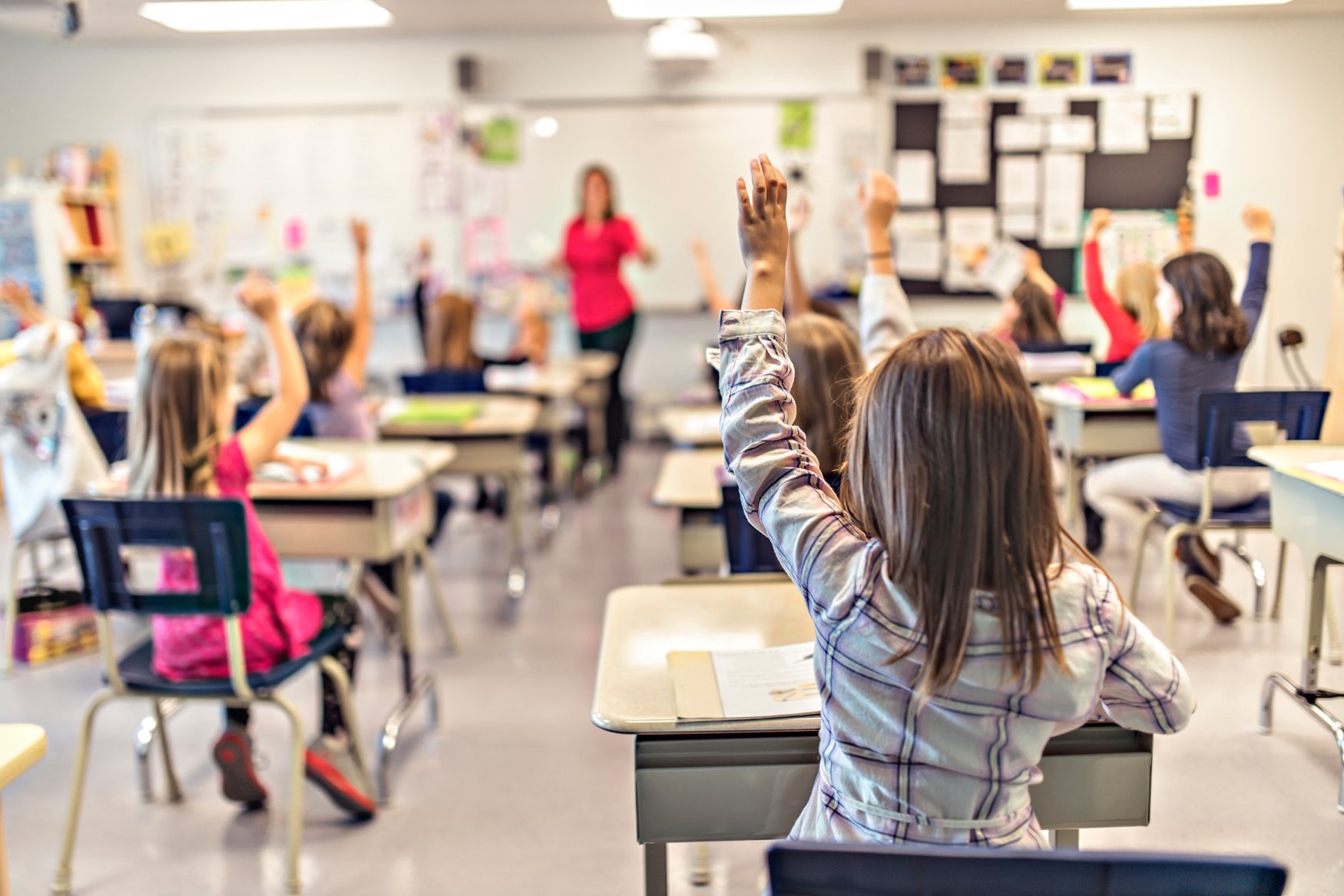 students raising hands