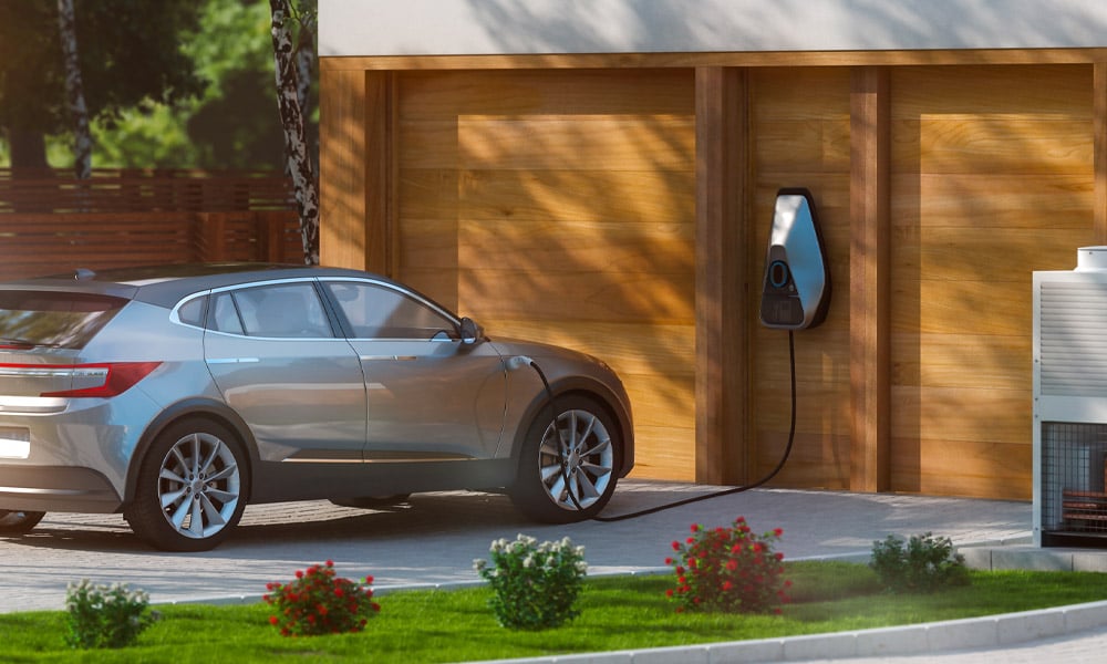 Car parked in front of home with EV charging unit