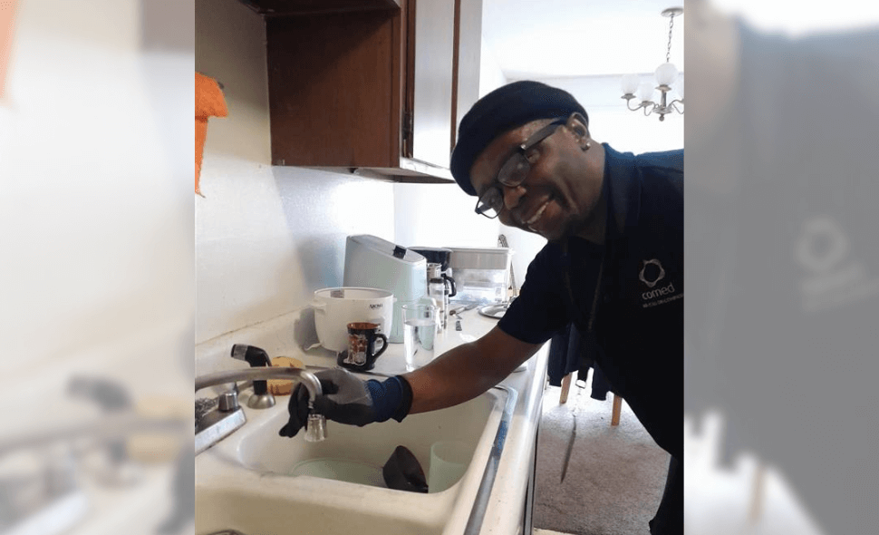 person installing a faucet aerator