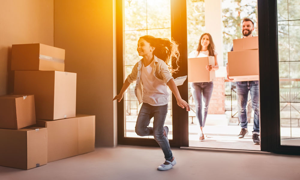 Small family moving in with little girl running in house